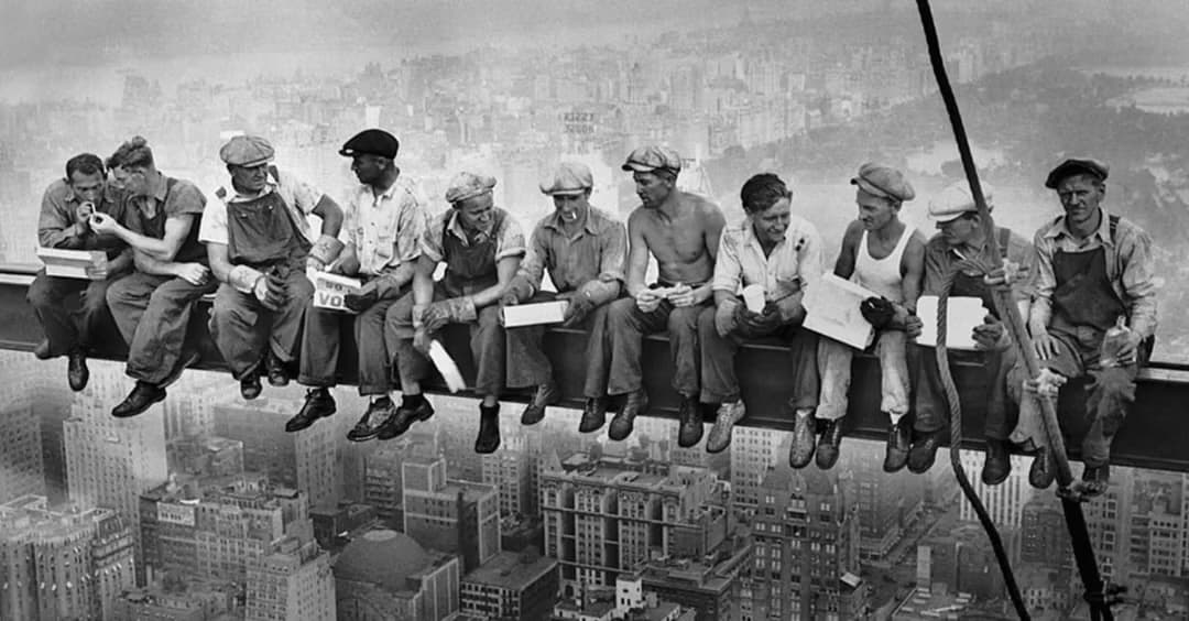 Ironworkers eating lunch on a steel beam high above New York City, 1932